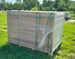 Pallet of Artisun solar panels wrapped in plastic, ready for installation