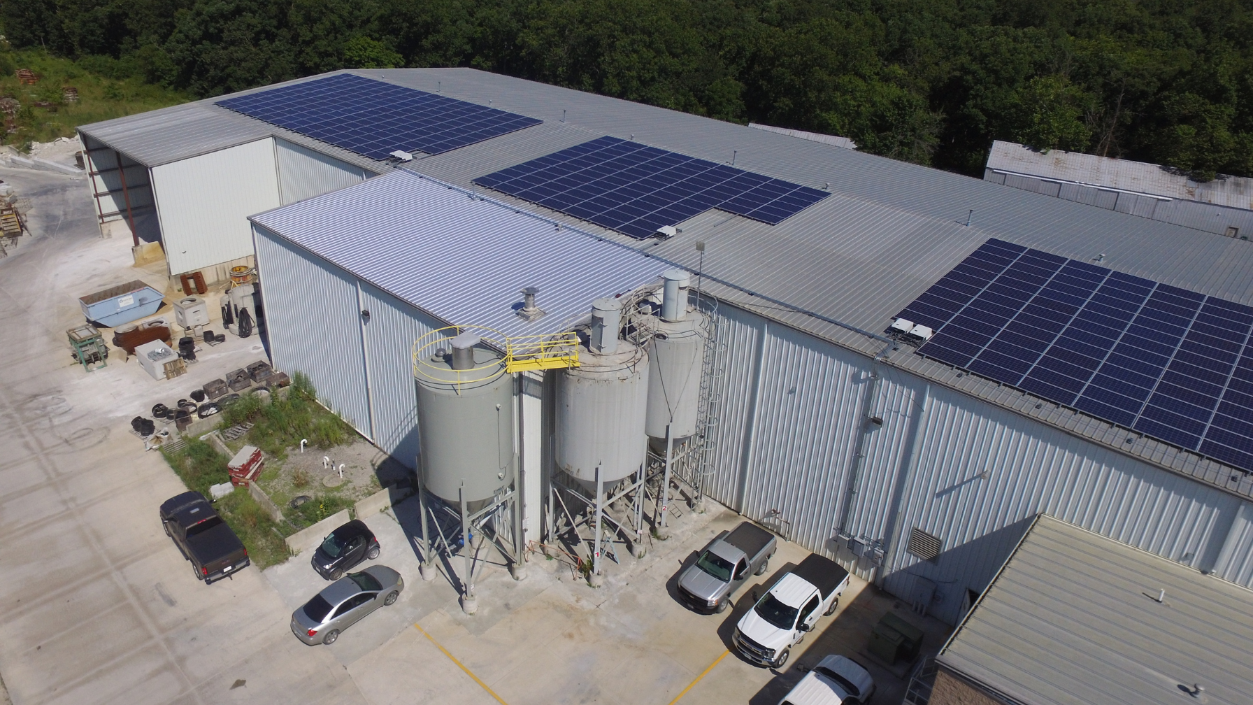 Artisun Solar project on Champion Precast building roof, industrial yard.