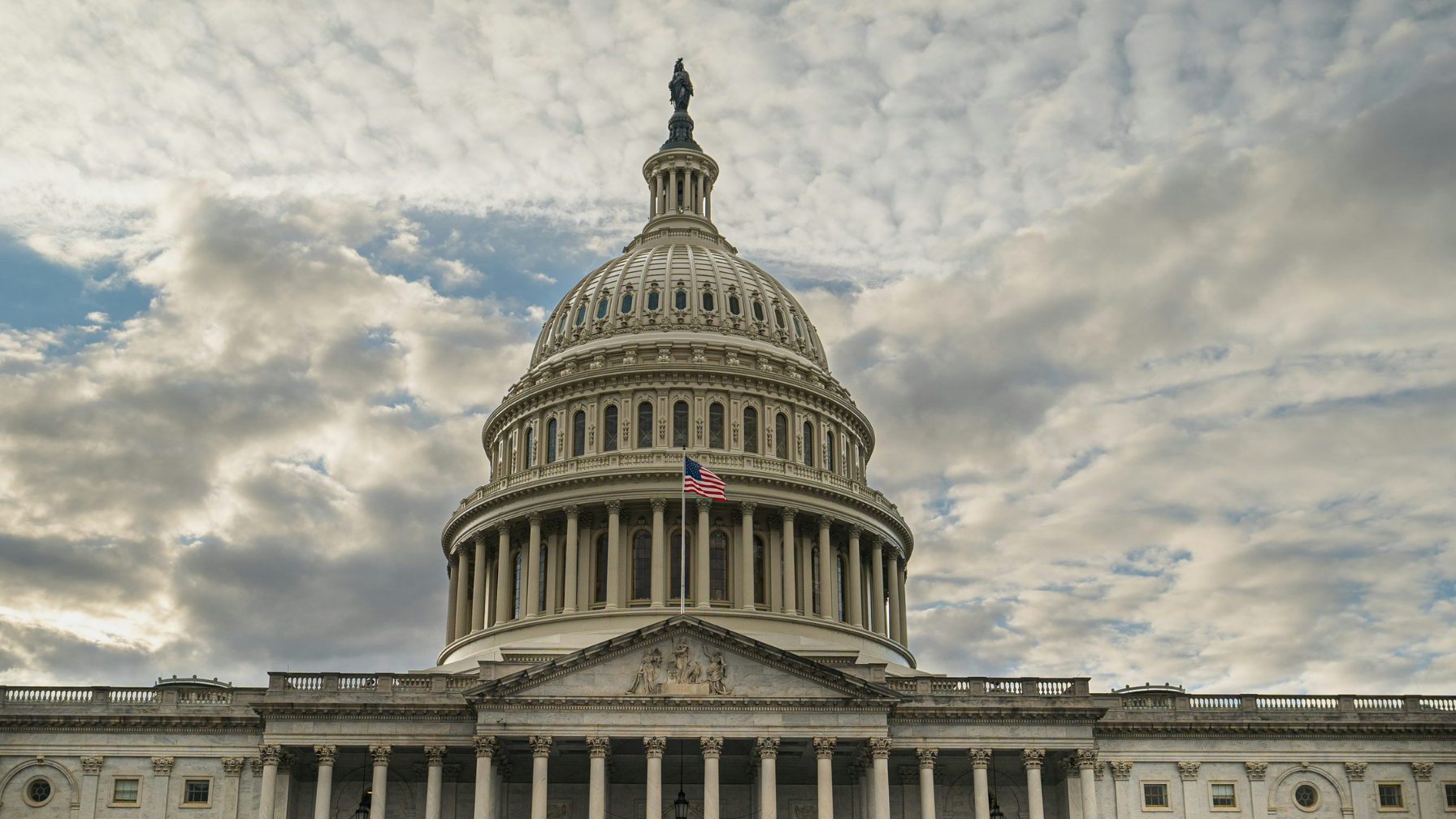 U.S. Capitol Building in Washington D.C. with American flag, symbolizing federal solar tax credit legislation and clean energy policy