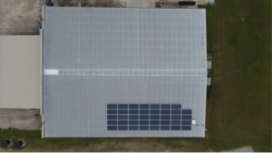 Bird's eye view of Trahan Construction warehouse featuring a commercial solar array by Artisun Solar.