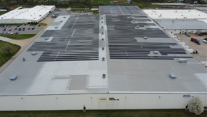Large-scale industrial rooftop solar panels on the Hubbell Power Systems manufacturing facility.