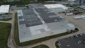 Close-up aerial of industrial solar panels on a metal roof at Hubbell Power Systems.