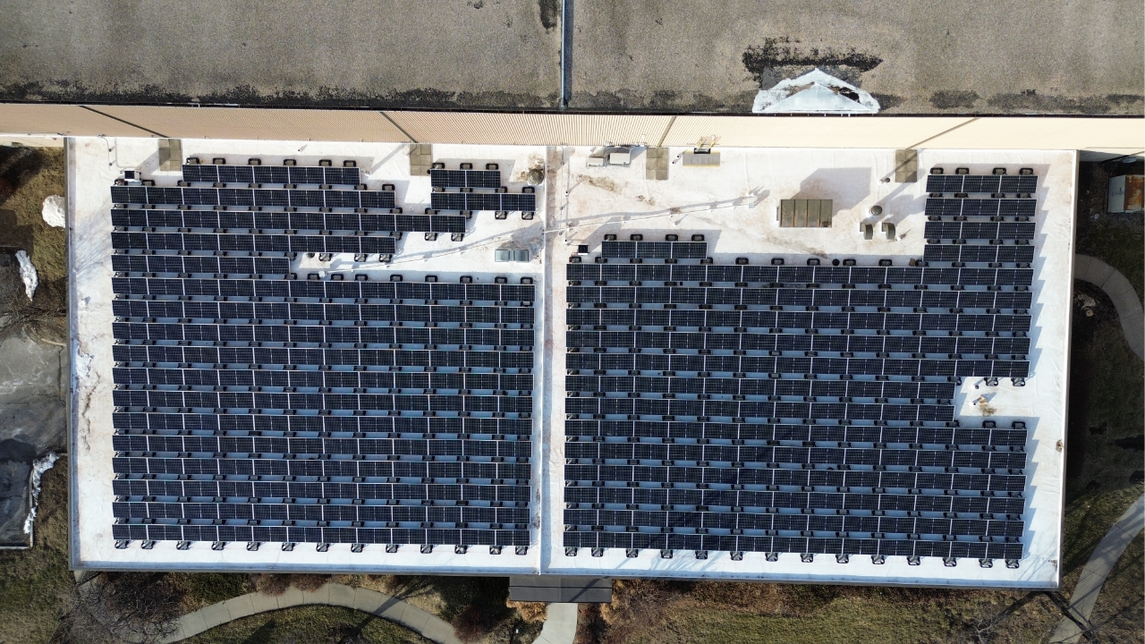 Overhead view of a flat-roof commercial solar array for Preston Refrigeration.