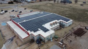 Aerial view of 4 T's Discount Foods in Hennessey, OK with a 149.7 kW rooftop solar array of 393 panels.