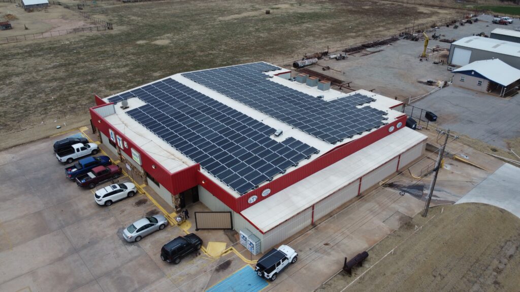 Aerial view of 4 T's Discount Foods in Hennessey, OK with a 149.7 kW rooftop solar array of 393 panels.