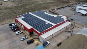 Aerial view of 4 T's Discount Foods in Hennessey, OK with a 149.7 kW rooftop solar array of 393 panels.