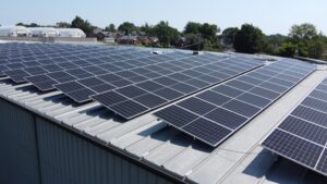 Aerial view of the Car-Anth Manufacturing facility in St. Louis, MO, showing the rooftop solar array installed by Artisun Solar.