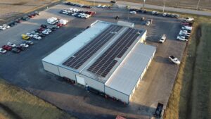 Birds-eye view of the 85kW AC solar installation at K&J, a dependable car dealership in Carlyle