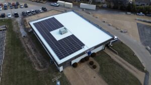 Angled aerial view of a 147-panel commercial solar panel system in Fenton, MO.