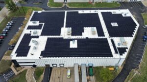 Drone view of a 1,577-panel commercial rooftop solar installation by Artisun Solar in Arnold, MO.