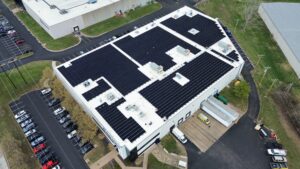Angled aerial view of a 630.8 kW DC rooftop solar array engineered for Sinclair & Rush by Artisun Solar.