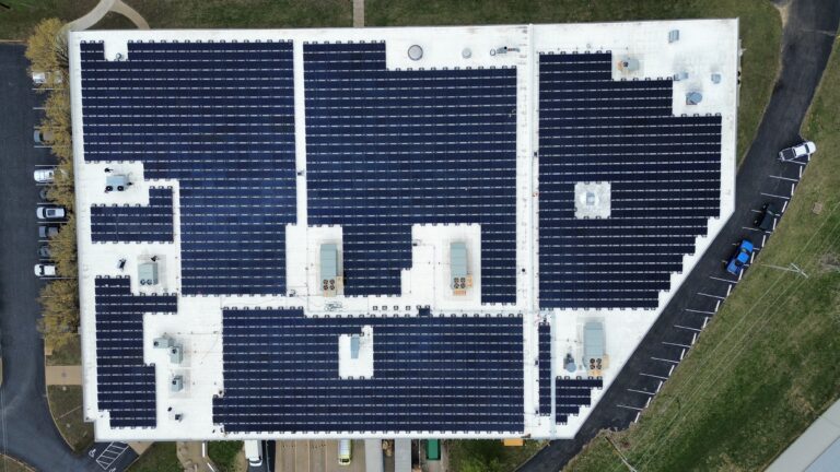 Top-down satellite view of a solar installation offsetting over 14,700 metric tons of CO2 emissions.