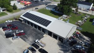 An overhead view of the complete 84-panel rooftop solar installation at Body Builders Collision & Glass in Robinson, IL.