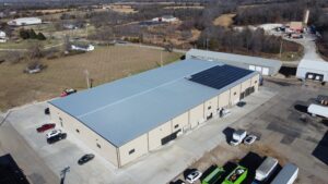 Aerial view of Busenbark Granite warehouse with a 100.3 kW rooftop solar array in Farmington, MO.