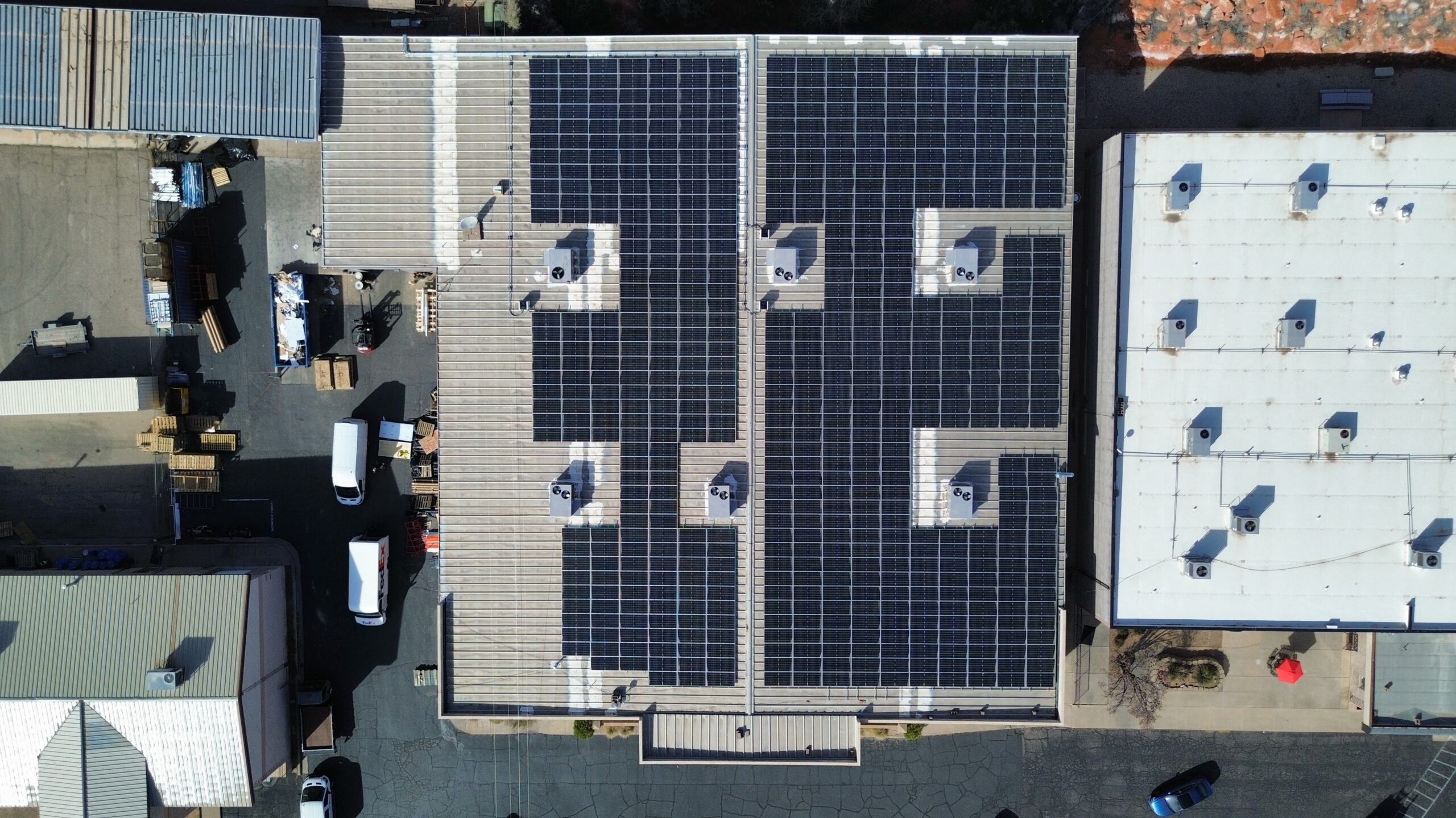 Straight top-down aerial photograph of the Design to Print facility roof, highlighting the symmetric grid engineering of the 250 kW (DC) solar system.