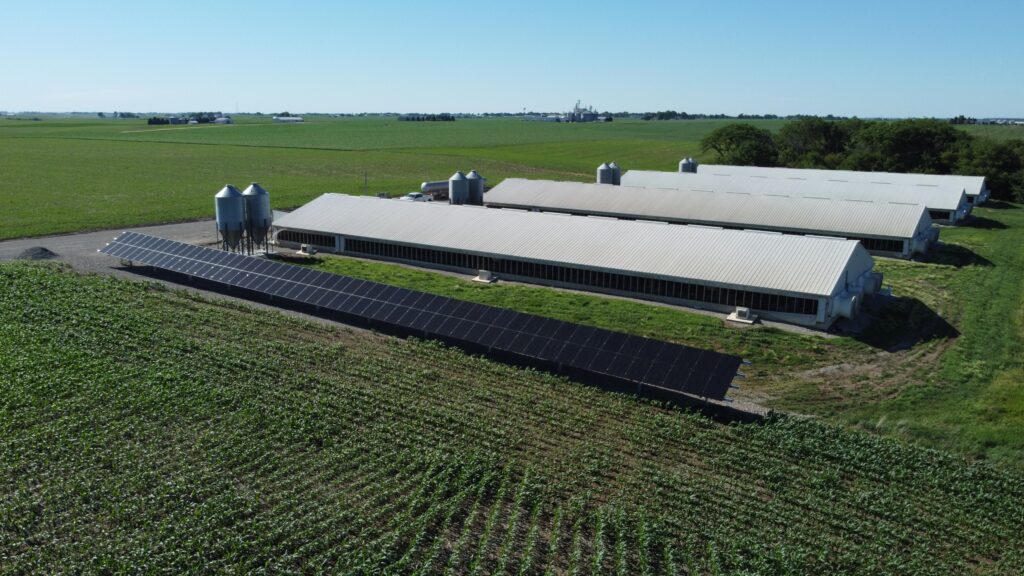Diagonal aerial view of Judson Vos farm solar array delivering 99.76% energy offset in Sully, IA.