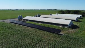 Diagonal aerial view of Judson Vos farm solar array delivering 99.76% energy offset in Sully, IA.