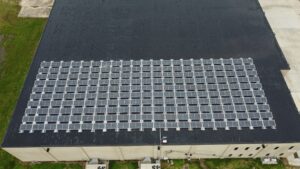 Wide aerial view of the Artisun Solar rooftop installation at Ultimate Air in Scott City, MO, projected to offset 1,976.8 metric tons of CO2 emissions over its operational life.