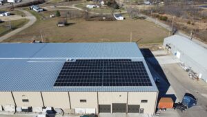 Aerial view of the Busenbark Granite 262-panel rooftop solar system offsetting 2,389.4 metric tons of CO₂ in Farmington, MO.