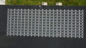 Top-down aerial view of the Ultimate Air rooftop solar installation in Scott City, MO, showing the 210-panel grid array engineered to achieve a 1.2-year payback period.