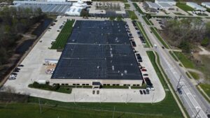 Eye-level aerial front view of the Jenne Distributors corporate headquarters, showcasing the rooftop solar array designed to achieve a rapid 2.5-year payback period.
