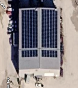 Aerial view of the 338-panel rooftop solar array at Mackey & Sons in Newton, KS, offsetting 98.19% of facility electricity use.