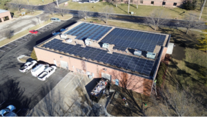 Aerial angled view of Artisun Solar HQ rooftop showing three distinct solar panel array configurations.